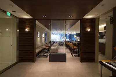 a lobby with a dining room with a table at First Cabin Akasaka in Tokyo