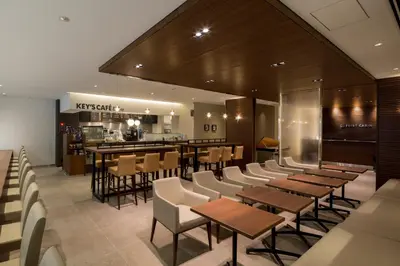 a restaurant with tables and chairs and a bar at First Cabin Akasaka in Tokyo