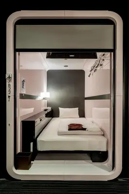 a room with a bed inside of a building at First Cabin Akasaka in Tokyo