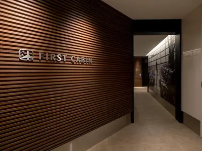 a first green sign on a wall in a building at First Cabin Akasaka in Tokyo