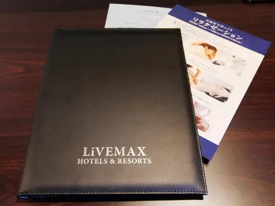 a black book sitting on top of a table at HOTEL LiVEMAX Asakusa Sky Front in Tokyo