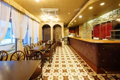 a restaurant with tables and chairs and a bar at Hotel Suntargas Ueno in Tokyo