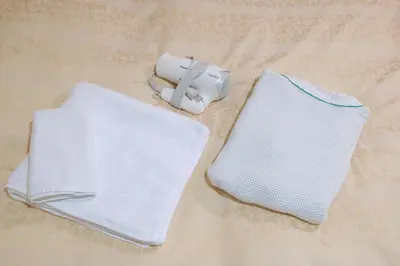 two towels sitting on a table with a blow dryer at Hotel Suntargas Ueno in Tokyo