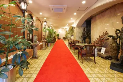 a red carpet in a hallway with plants at Hotel Suntargas Ueno in Tokyo