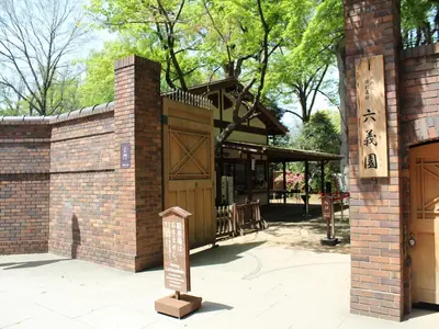 a sign in front of a building with a gate at APA Hotel Sugamo Ekimae in Tokyo