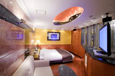 a bedroom with a bed and a flat screen tv at HOTEL & SPA J-MEX Shinjuku Kabukicho (Adult Only) in Tokyo