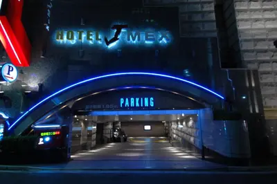 a tunnel in a building with a blue neon sign at HOTEL & SPA J-MEX Shinjuku Kabukicho (Adult Only) in Tokyo