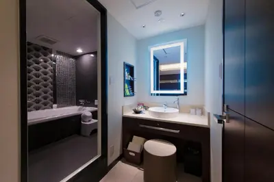 a bathroom with a toilet and a sink and a tub at Hotel Moana Shinjuku (Adult Only) in Tokyo
