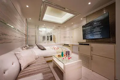 a living room with a white couch and a tv at Hotel Moana Shinjuku (Adult Only) in Tokyo