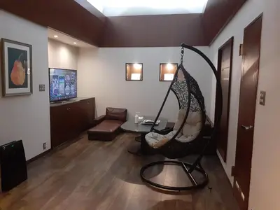 a room with a hammock chair in a living room at Hotel Moana Otsuka (Adult Only) in Tokyo
