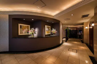 a lobby of a hotel with flowers on a counter at HOTEL PAL Otsuka -Adult Only- in Tokyo