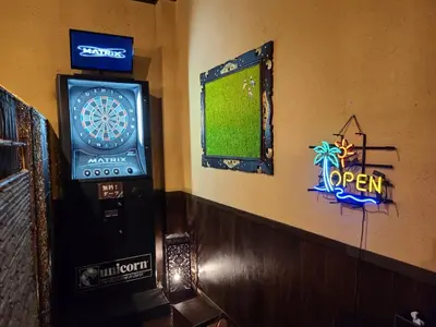 a pinball machine and a dart board on a wall at Hotel Balian Resort Kinshicho in Tokyo