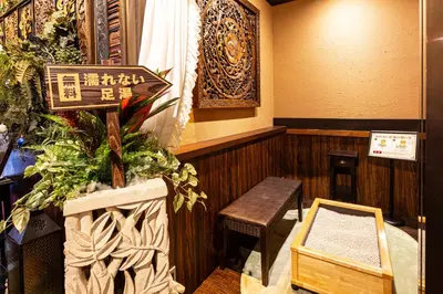 a restaurant with a sign and a bench in a room at Hotel Balian Resort Kinshicho in Tokyo