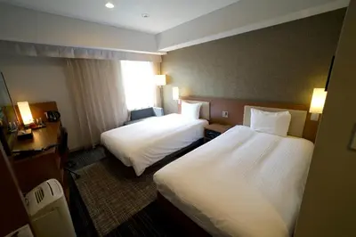 a hotel room with two beds and a window at ibis Styles Tokyo Ginza in Tokyo