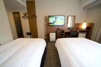 a hotel room with two beds and a flat screen tv at ibis Styles Tokyo Ginza in Tokyo