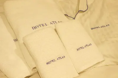 two open books on top of a white shirt at HOTEL ATLAS Shinkabukicho (Adult Only) in Tokyo