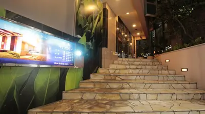a set of stairs in a building with a sign at HOTEL ATLAS Shinkabukicho (Adult Only) in Tokyo