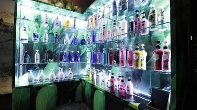 a display case filled with lots of different colored bottles at HOTEL ATLAS Shinkabukicho (Adult Only) in Tokyo
