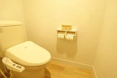 a bathroom with a toilet with a remote control at HOTEL ATLAS Shinkabukicho (Adult Only) in Tokyo