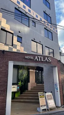 a hotel atlas sign in front of a building at HOTEL ATLAS Shinkabukicho (Adult Only) in Tokyo