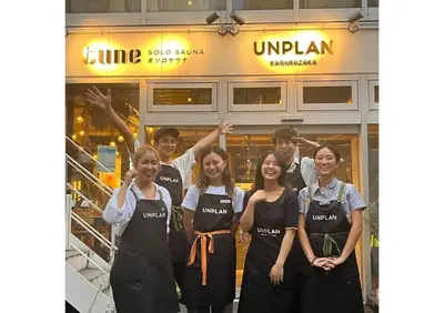 a group of people standing in front of a store at UNPLAN Kagurazaka in Tokyo