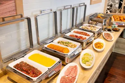 a buffet with many trays of different types of food at Hotel Mystays Premier Akasaka in Tokyo