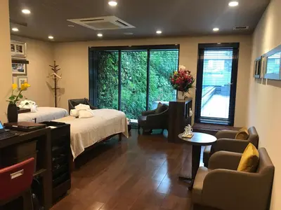 a hotel room with two beds and a living room at Hotel Mystays Premier Akasaka in Tokyo