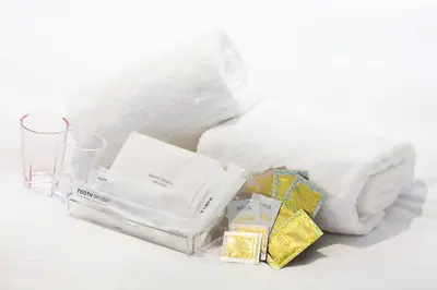 a pile of white towels and a glass at Hotel Mystays Premier Akasaka in Tokyo