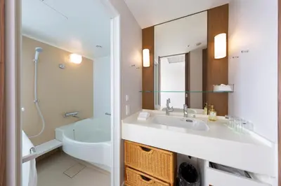 a bathroom with a sink and a toilet and a mirror at MAIHAMA VIEW HOTEL by HULIC Formerly Tokyo Bay Maihama Hotel in Urayasu