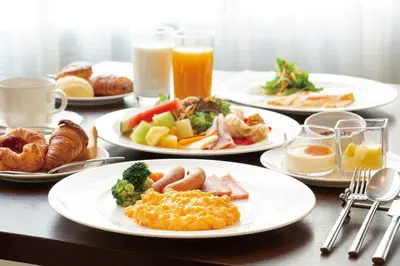 a table with plates of breakfast foods and drinks at MAIHAMA VIEW HOTEL by HULIC Formerly Tokyo Bay Maihama Hotel in Urayasu