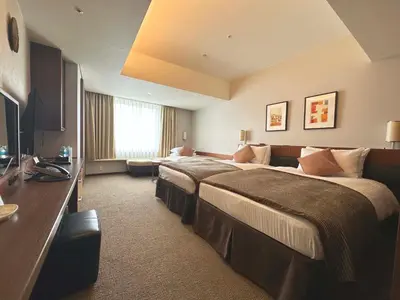 a hotel room with two beds and a television at MAIHAMA VIEW HOTEL by HULIC Formerly Tokyo Bay Maihama Hotel in Urayasu
