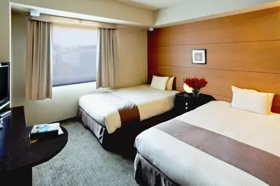 a hotel room with two beds and a window at Citadines Central Shinjuku Tokyo in Tokyo
