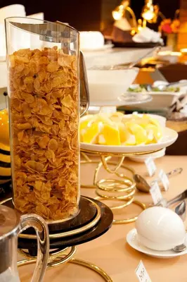 a glass jar filled with stones on a table with fruit at Citadines Central Shinjuku Tokyo in Tokyo