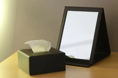 a black box sitting on a table next to a mirror at HOTEL AMANEK Ginza East in Tokyo
