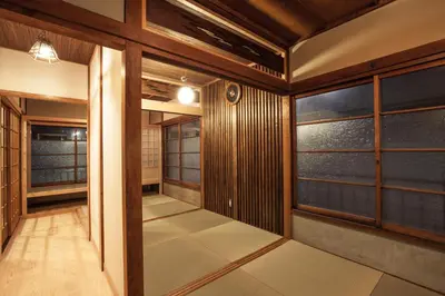 a japanese room with wooden walls and windows at Araiya Tokyo -Private Townhouse- in Tokyo