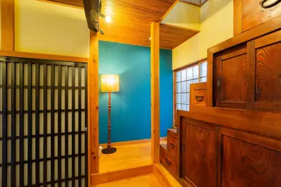 a room with a blue wall and a floor lamp at Araiya Tokyo -Private Townhouse- in Tokyo