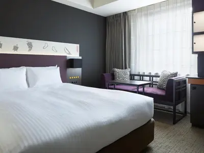 a hotel room with a bed and a chair at Mitsui Garden Hotel Kyobashi - Tokyo Station in Tokyo