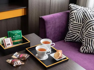 a tray with two cups of coffee and bread on a table at Mitsui Garden Hotel Kyobashi - Tokyo Station in Tokyo