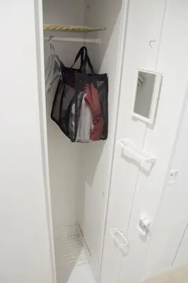 a closet with a bag hanging on a hook at Akihabara Bay Hotel (Female Only) in Tokyo