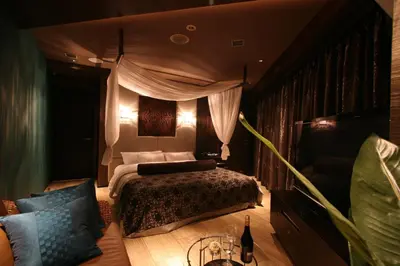 a bedroom with a bed and a couch at Hotel VARKIN in Tokyo