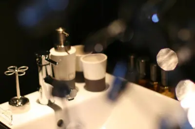 a bathroom counter with a sink with a lot of bottles at Hotel VARKIN in Tokyo