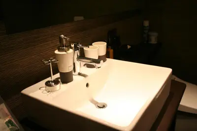 a white bathroom sink with two cups on it at Hotel VARKIN in Tokyo