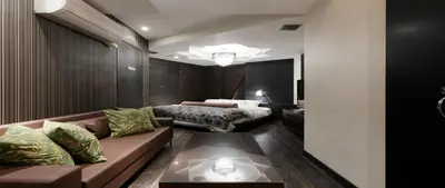 a living room with a couch and a bed at Hotel VARKIN in Tokyo