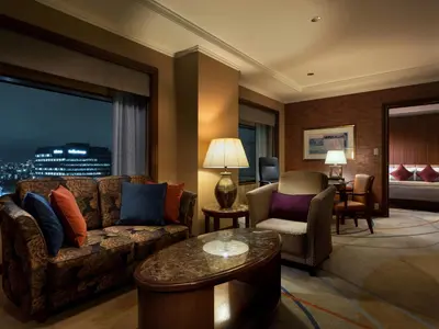 a living room with a couch and a table at Hotel Metropolitan Tokyo Ikebukuro in Tokyo