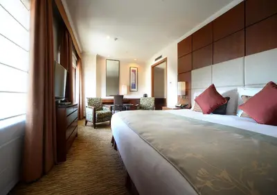 a hotel room with a large bed and a desk at Hotel Metropolitan Tokyo Ikebukuro in Tokyo