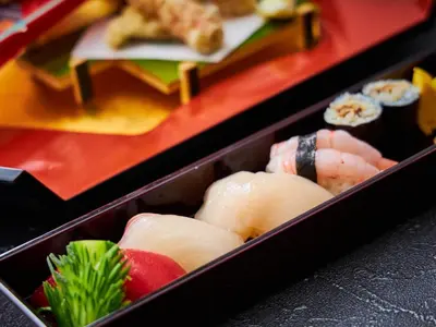 a box filled with sushi on a table at Hotel Metropolitan Tokyo Ikebukuro in Tokyo