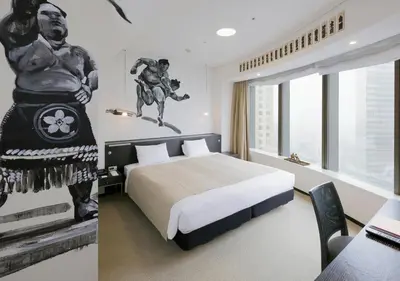 a hotel room with a bed and a statue of a man riding a horse at Park Hotel Tokyo in Tokyo