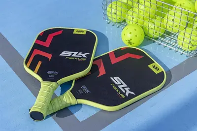 a tennis racket and a ball on a tennis court at Hilton Tokyo Hotel in Tokyo
