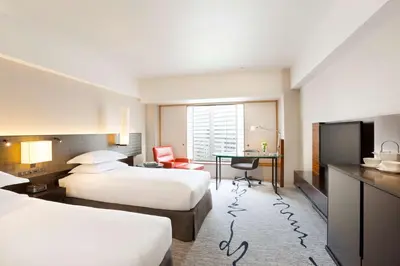 a hotel room with two beds and a desk at Hilton Tokyo Hotel in Tokyo