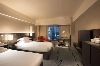 a hotel room with two beds and a desk at Hilton Tokyo Hotel in Tokyo